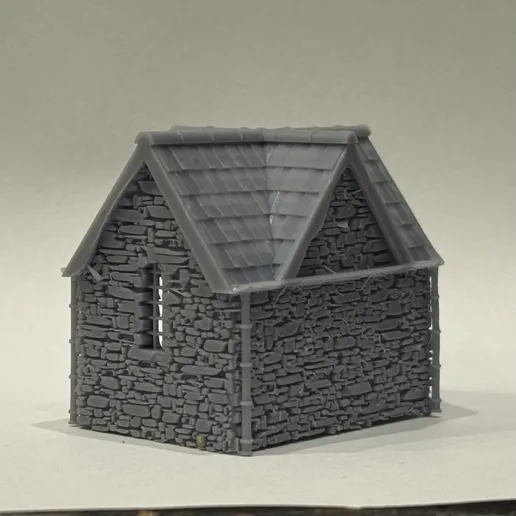 Rear three-quarter view of the printed bus stop showing the solid dressed stone back and side walls under the slate roof.