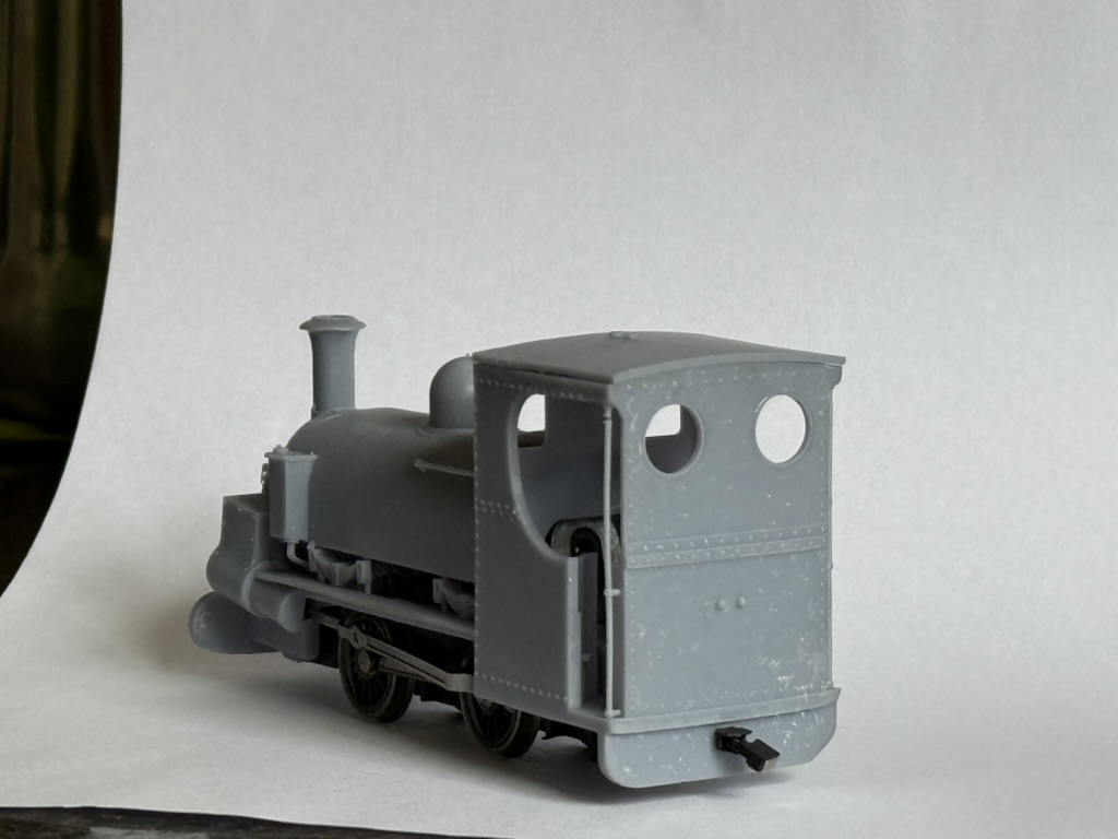 Rear three-quarter view of the unpainted printed Charles showing the cab back with round spectacle windows and rivet detail.