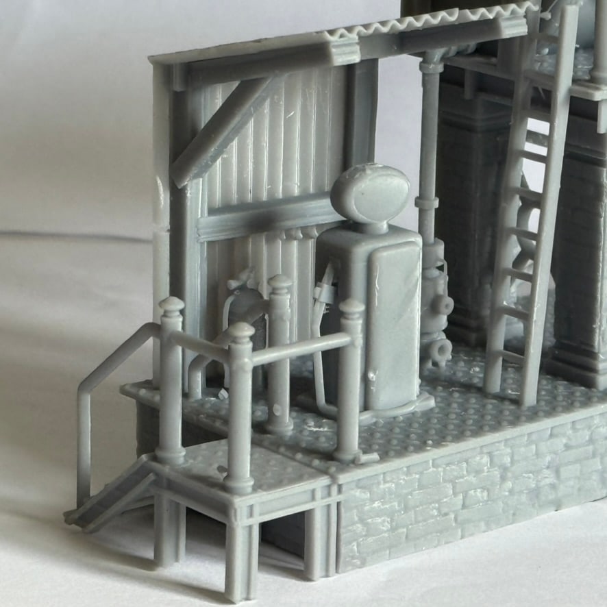 Close-up of the diesel fuelling station model showing the pump, railings, ladder, and platform texture