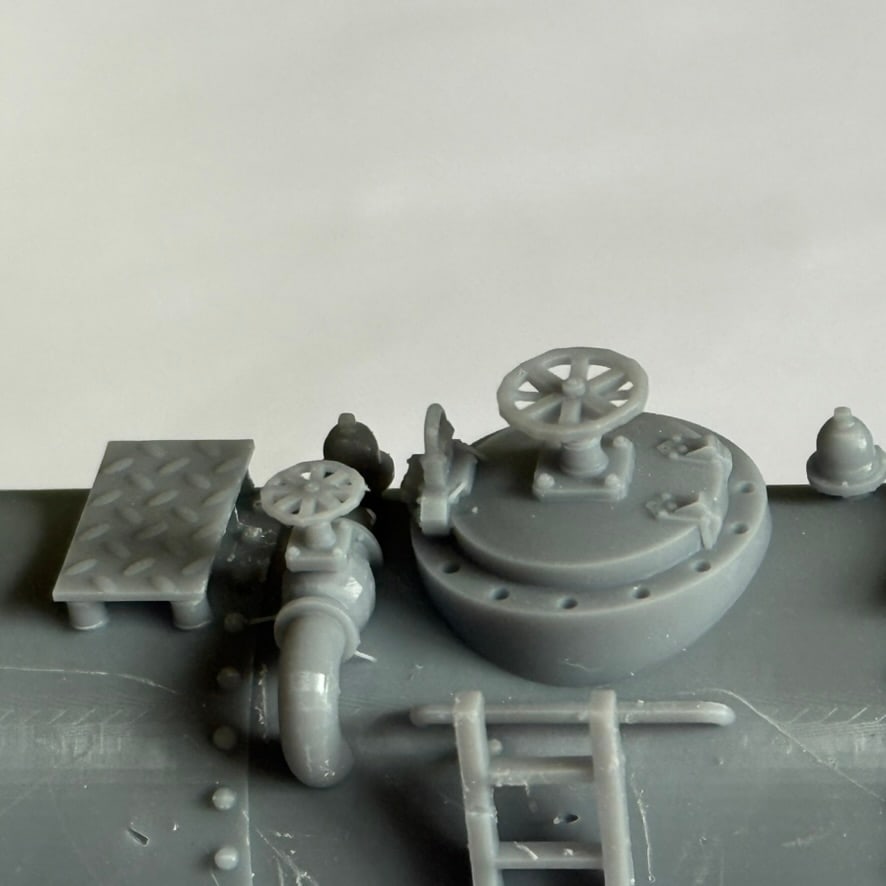 Close-up of the tank top fittings and hand wheels on the diesel fuelling station model