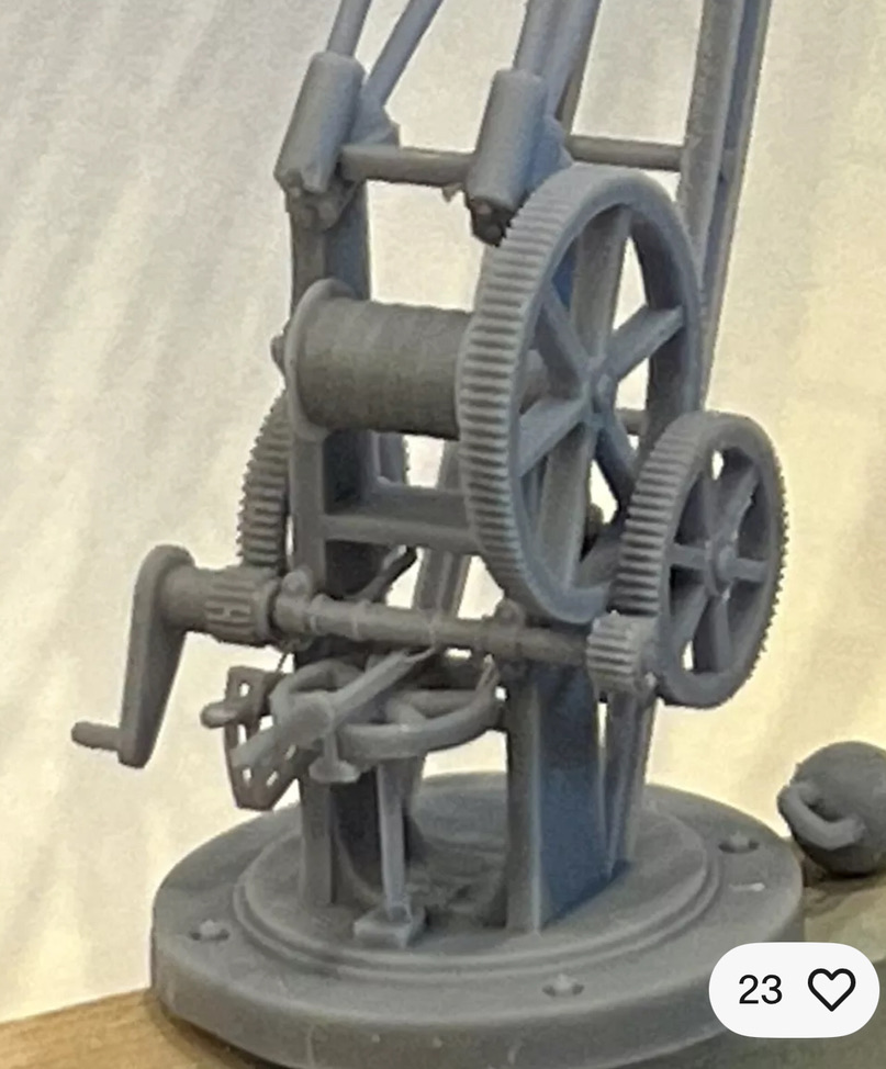 Close-up of the printed wharfside crane winding mechanism showing gears, hand crank and circular base.