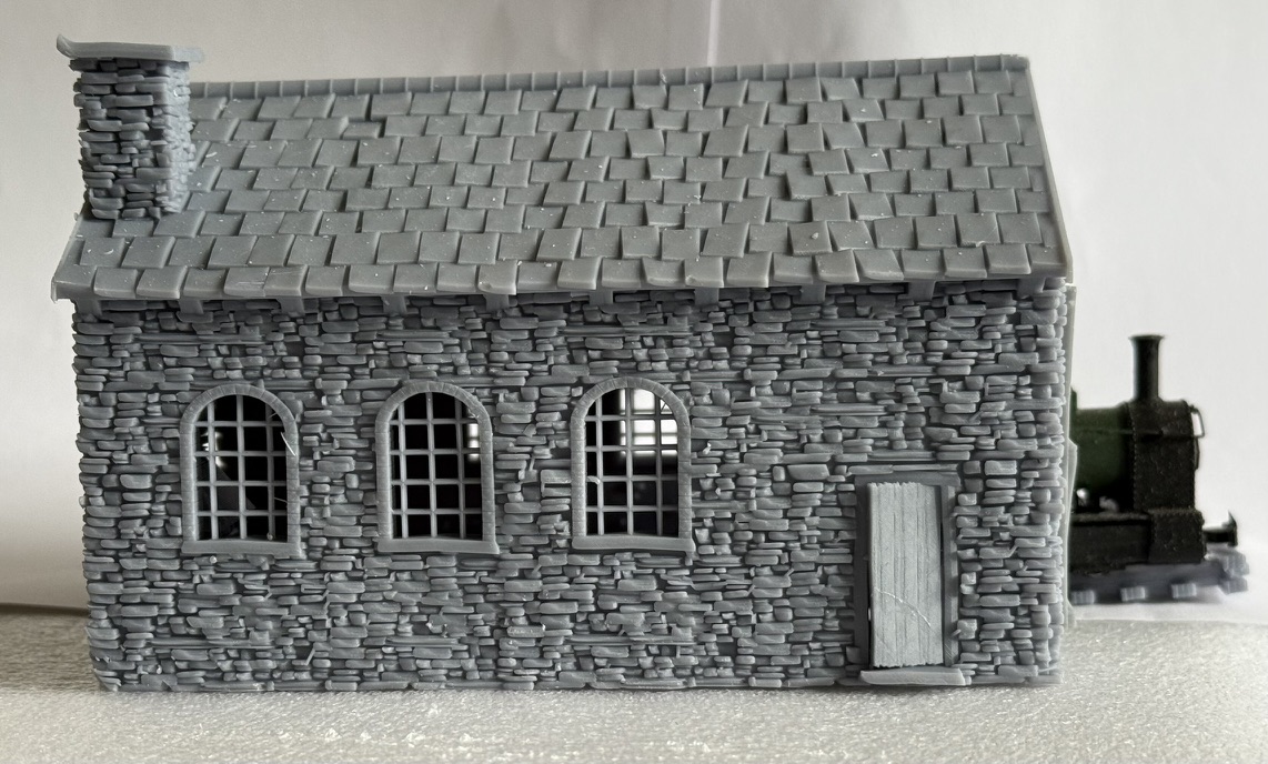 Side view of the 009 loco shed showing the slate roof, chimney, arched windows and small side door