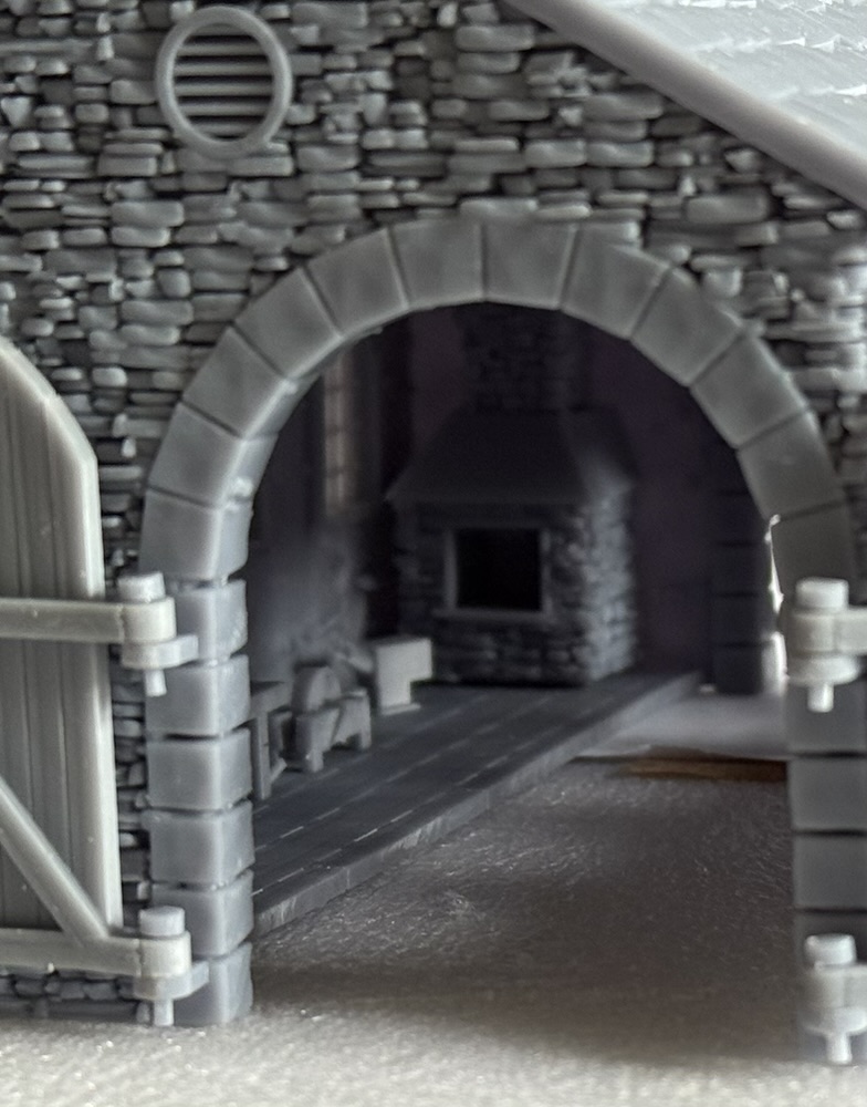 View through the stone arch of the 009 loco shed to the workshop forge and bench inside