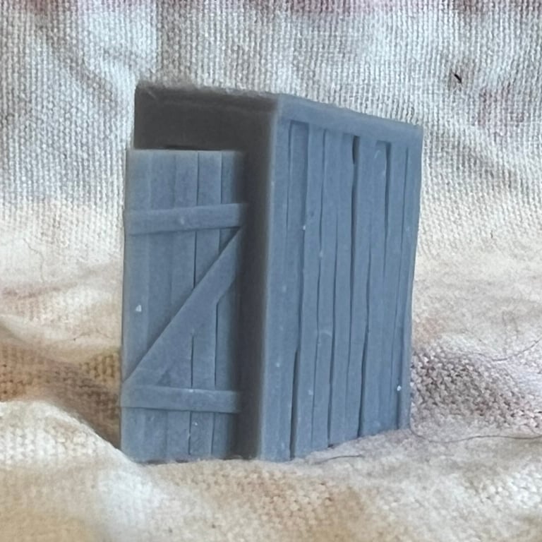 Printed privy from the hinge side, showing the ledged and braced door closed against the plank walls.