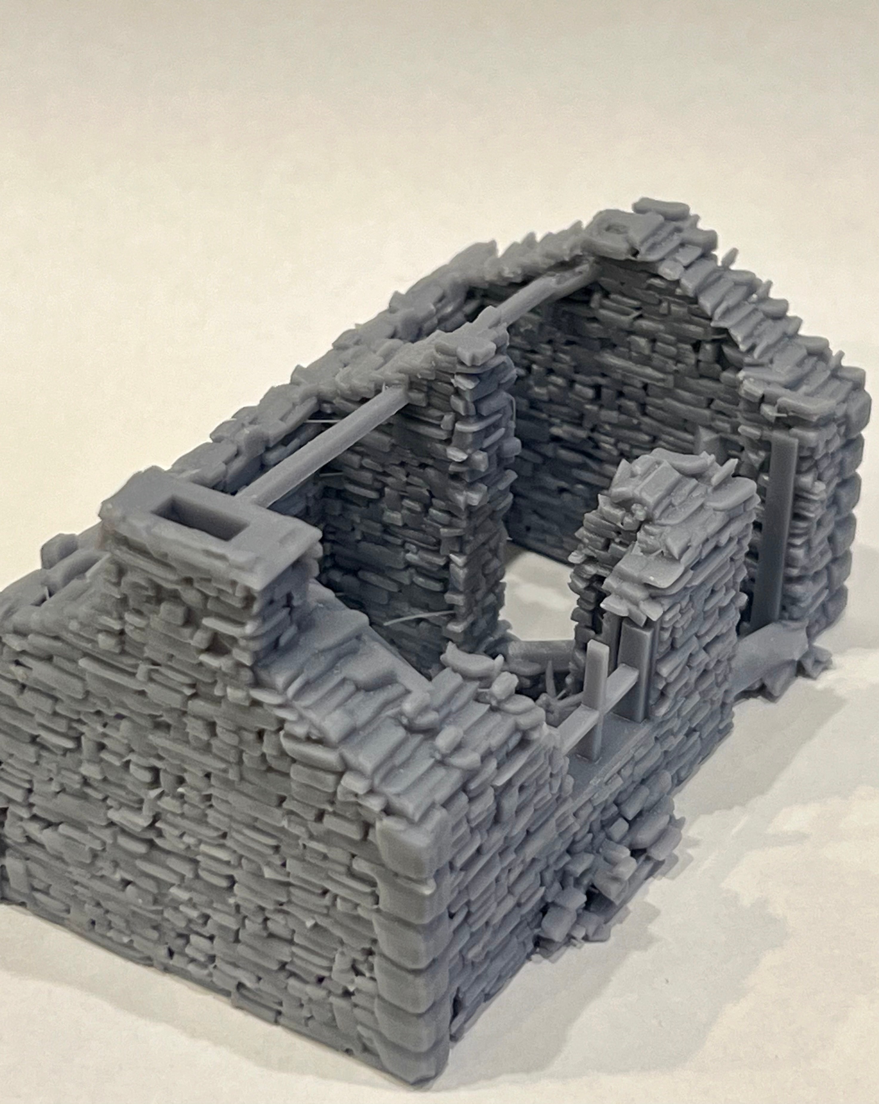 Side view of the ruined cottage model showing irregular stone courses and broken wall tops
