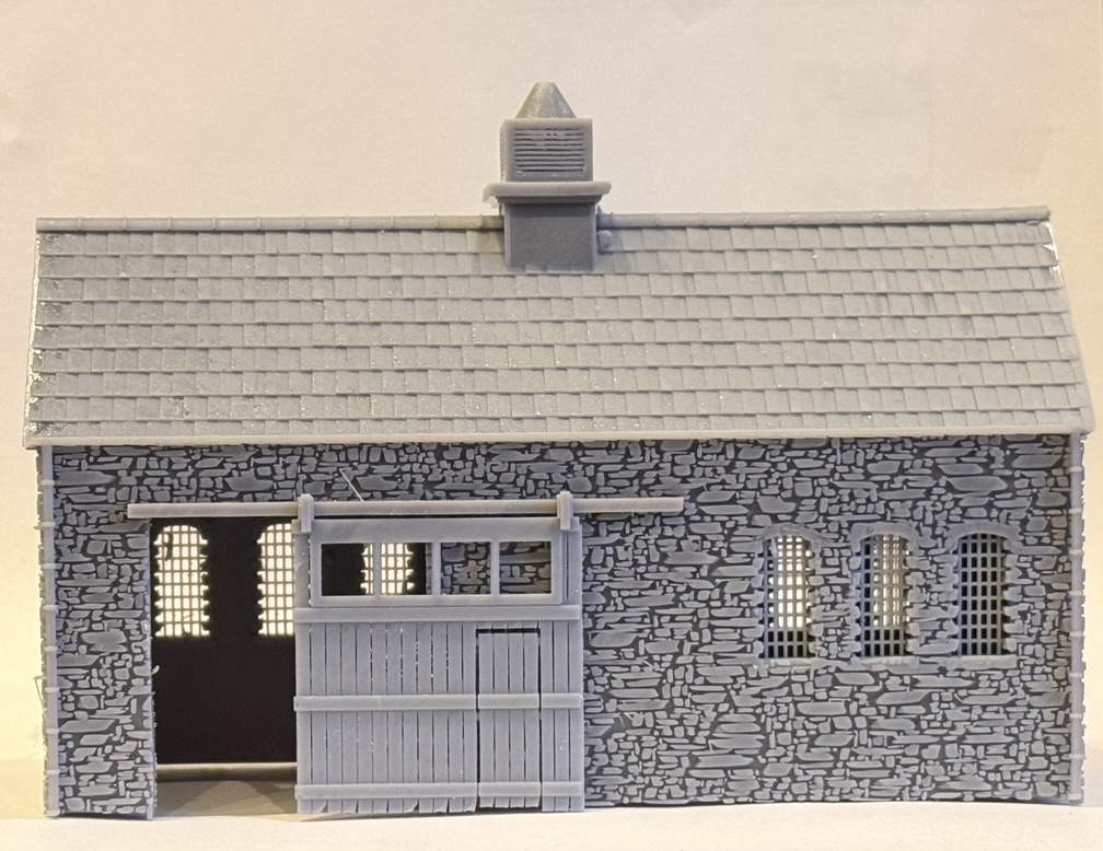 Front view of the printed workshop with its sliding door pulled back along the rail to show the open doorway.