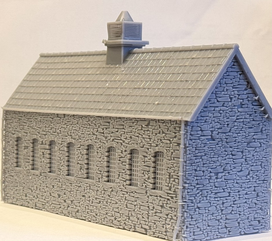 Rear of the printed workshop showing a row of eight arched windows with glazing bars set in the stone wall.