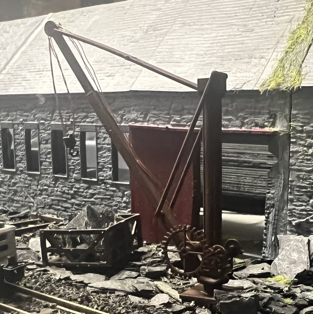 Freelance small crane model posed in a stone quarry scene with track and workshop detail