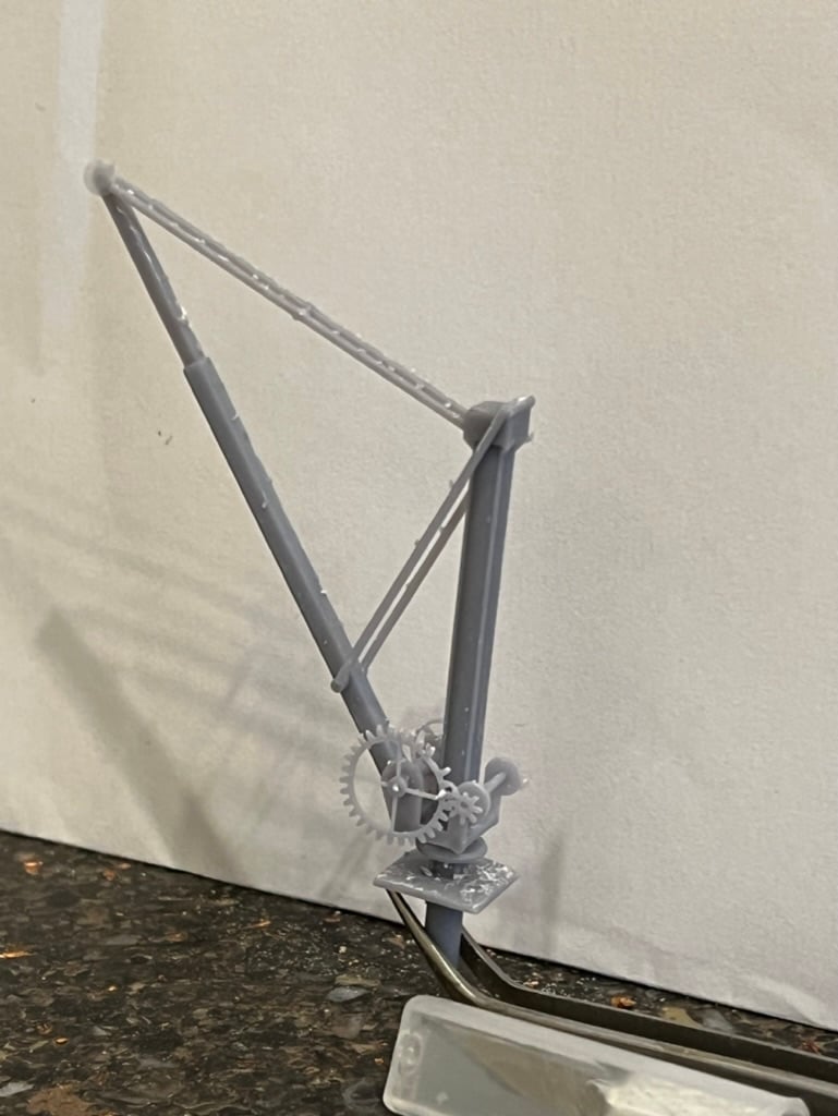 Unpainted grey resin print of the small crane standing upright, showing the jib, tie bars, post and winding gears.
