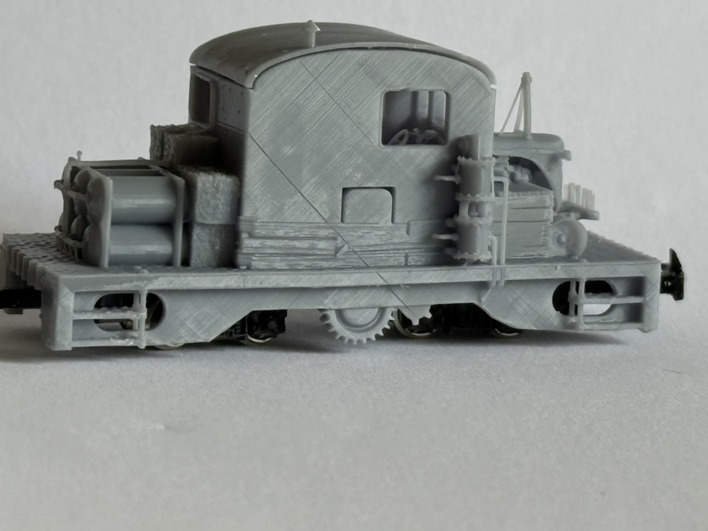 Side profile of the printed tractor loco body on its chassis with cab, platform details and wagon-style side panels.