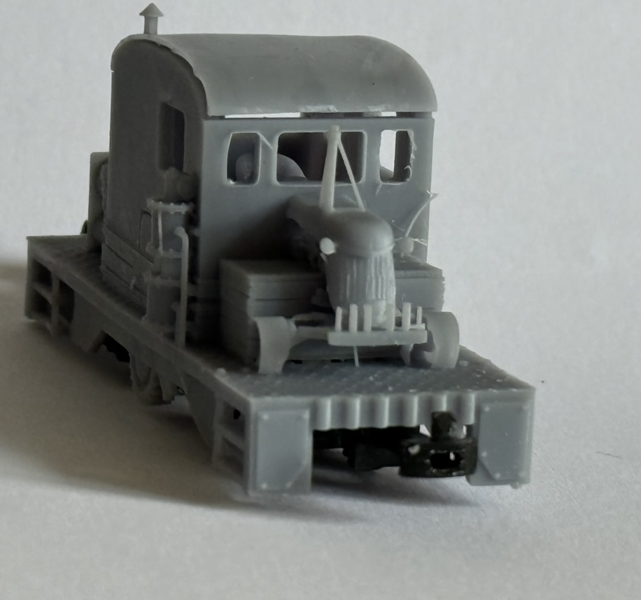 Front three-quarter view of the printed tractor loco with cab, bonnet, front platform and visible coupling.