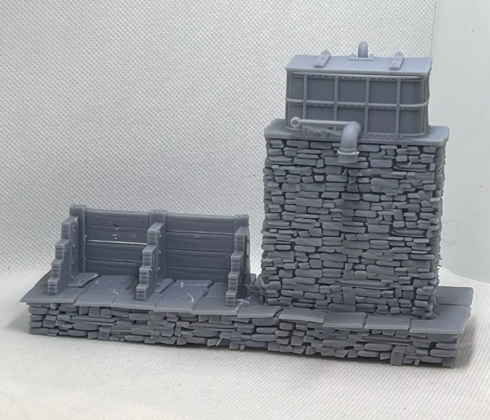 Front view of the printed water tower and coaling stage with stone base, plank coal bays and tank detail.