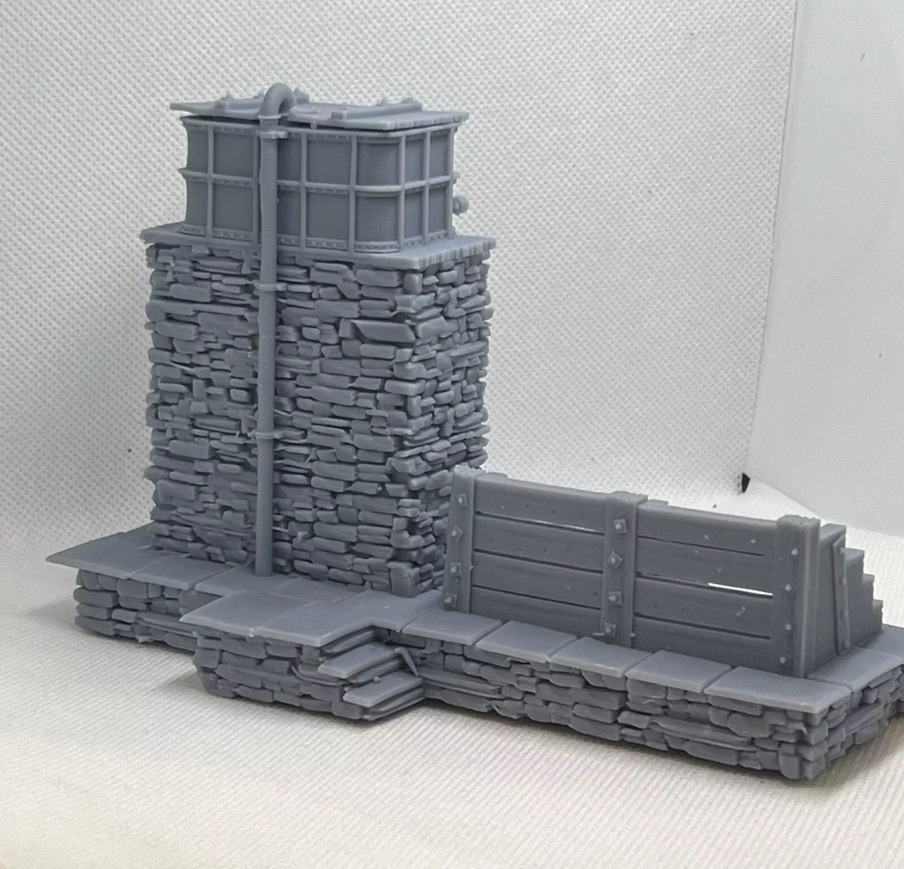 Rear and side view of the printed water tower and coaling stage showing stone steps, tank pipework and coal bay walls.